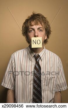 Stock Photo - young man with 
'no' note over 
lips. fotosearch 
- search stock 
photos, pictures, 
images, and photo 
clipart