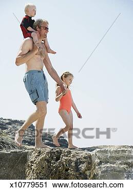 Stock Photography - father carrying 
son (2-4) on shoulders, 
holding daughter's 
(4-6) hand. fotosearch 
- search stock 
photos, pictures, 
images, and photo 
clipart