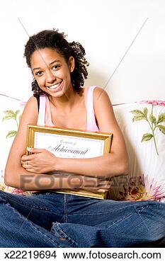 Stock Photo - teenage girl (12-14) 
holding achievement 
award, smiling, 
portrait. fotosearch 
- search stock 
photos, pictures, 
images, and photo 
clipart