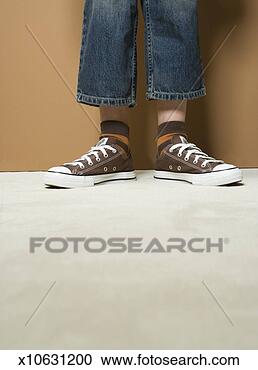 Stock Photography - boy (8-9) wearing 
short jeans, low 
section. fotosearch 
- search stock 
photos, pictures, 
images, and photo 
clipart