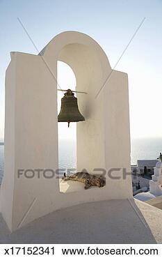 Stock Photography - greece, cyclades, 
santorini, oia, 
cat sleeping under 
church bell. fotosearch 
- search stock 
photos, pictures, 
images, and photo 
clipart