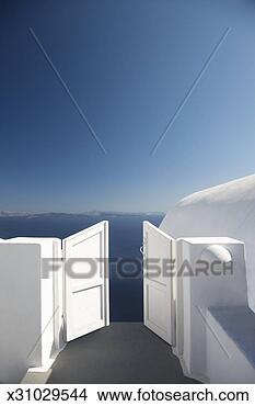 Stock Photo - greece, cyclades, 
santorini, oia, 
open gate above 
sea. fotosearch 
- search stock 
photos, pictures, 
images, and photo 
clipart