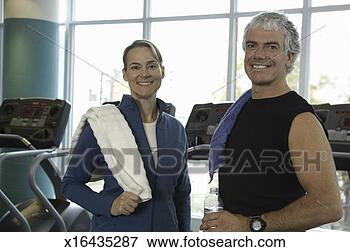 Picture - man and woman 
in health club, 
smiling, portrait. 
fotosearch - search 
stock photos, 
pictures, images, 
and photo clipart