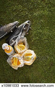 Stock Photo - plastic bags of 
oranges,  water 
bottle,  and cleats 
on sports field. 
fotosearch - search 
stock photos, 
pictures, images, 
and photo clipart