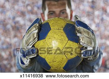 Stock Photo - soccer goalie 
holding soccer 
ball in goal, 
focus on ball. 
fotosearch - search 
stock photos, 
pictures, images, 
and photo clipart
