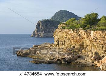 Stock Photo - spain, balearic 
islands, ibiza, 
rugged coastline. 
fotosearch - search 
stock photos, 
pictures, images, 
and photo clipart