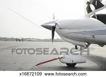 Stock Photograph - stationary propeller 
plane with tow 
device on runway, 
side view. fotosearch 
- search stock 
photos, pictures, 
images, and photo 
clipart