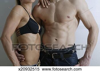 Stock Image - young man and 
woman tensing 
upper body muscles. 
fotosearch - search 
stock photos, 
pictures, images, 
and photo clipart