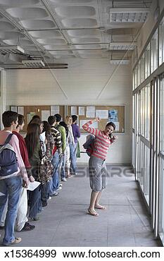 Stock Photograph - young woman waving 
arm by queue of 
young adults. 
fotosearch - search 
stock photos, 
pictures, images, 
and photo clipart