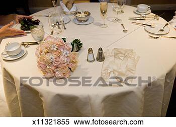Stock Image - bride sitting 
at dining table 
(focus on bouquet 
and gloves on 
table). fotosearch 
- search stock 
photos, pictures, 
images, and photo 
clipart