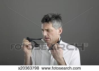 Stock Photo - mature man trying 
to tie bow tie. 
fotosearch - search 
stock photos, 
pictures, images, 
and photo clipart
