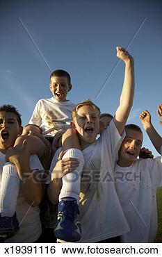 Stock Photo - boys (11-13) in 
football team 
carrying team 
mate on field, 
cheering. fotosearch 
- search stock 
photos, pictures, 
images, and photo 
clipart