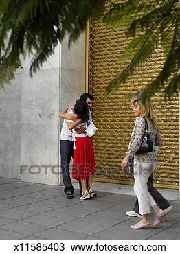 Stock Photo - couple walking 
past young couple 
embracing in street. 
fotosearch - search 
stock photos, 
pictures, images, 
and photo clipart