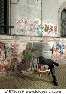 Stock Photograph - mature man sitting 
against wall with 
graffiti reading 
newspaper. fotosearch 
- search stock 
photos, pictures, 
images, and photo 
clipart