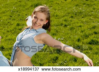 Picture - teenage boy (16-18) 
holding up teenage 
girl (15-17) in 
field, smiling. 
fotosearch - search 
stock photos, 
pictures, images, 
and photo clipart