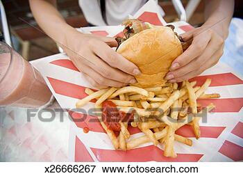 Picture - hands of woman 
holding hamburger, 
close-up. fotosearch 
- search stock 
photos, pictures, 
images, and photo 
clipart