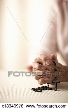 Stock Photo - senior woman with 
hands clasped, 
 holding rosary, 
 mid section. 
fotosearch - search 
stock photos, 
pictures, images, 
and photo clipart
