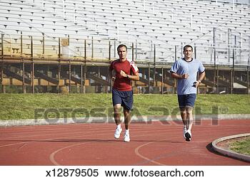 Stock Image - two men running 
on track at track 
and field stadium. 
fotosearch - search 
stock photos, 
pictures, images, 
and photo clipart