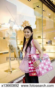 Stock Photo - woman with shopping 
bags near department 
store, smiling, 
portrait. fotosearch 
- search stock 
photos, pictures, 
images, and photo 
clipart