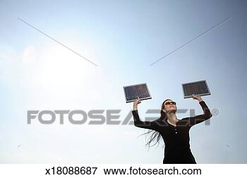 Picture - woman with solar 
panels, low angle 
view. fotosearch 
- search stock 
photos, pictures, 
images, and photo 
clipart