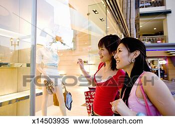 Stock Image - women looking 
at mannequin in 
department store, 
smiling. fotosearch 
- search stock 
photos, pictures, 
images, and photo 
clipart