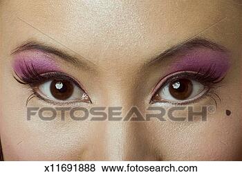Stock Photo - young woman with 
brown eyes wearing 
false eyelashes 
and colourful. 
fotosearch - search 
stock photos, 
pictures, images, 
and photo clipart