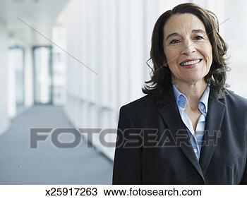 Stock Photo - businesswoman 
smiling in hallway, 
smiling, portrait. 
fotosearch - search 
stock photos, 
pictures, images, 
and photo clipart