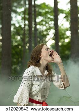 Stock Photo - woman in old-fashioned 
dress in forest, 
 holding hand 
to mouth and. 
fotosearch - search 
stock photos, 
pictures, images, 
and photo clipart