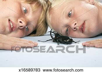 Stock Photo - girl and boy (8-11) 
lying down head 
to head and looking 
at large. fotosearch 
- search stock 
photos, pictures, 
images, and photo 
clipart