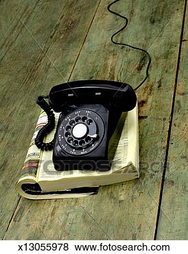 Stock Photo - old fashioned 
phone on phone 
book on wooden 
table. fotosearch 
- search stock 
photos, pictures, 
images, and photo 
clipart