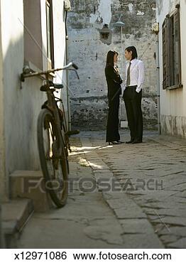 Stock Photo - china,  tong li 
water town,  man 
and woman talking 
 in narrow street. 
fotosearch - search 
stock photos, 
pictures, images, 
and photo clipart