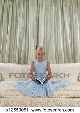 Stock Photography - girl (8-9) in 
formal dress, 
 sitting on formal 
couch,  reading 
book. fotosearch 
- search stock 
photos, pictures, 
images, and photo 
clipart