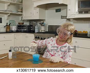 Stock Photograph - girl (8-9) doing 
science experiment 
in pajamas at 
kitchen table. 
fotosearch - search 
stock photos, 
pictures, images, 
and photo clipart