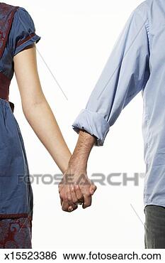 Stock Photo - mid adult couple 
holding hands, 
mid section. fotosearch 
- search stock 
photos, pictures, 
images, and photo 
clipart