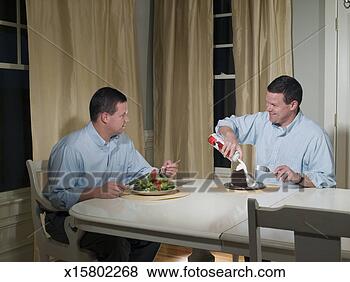 Stock Photo - mid adult man 
eating salad, 
 twin brother 
eating chocolate 
cake. fotosearch 
- search stock 
photos, pictures, 
images, and photo 
clipart
