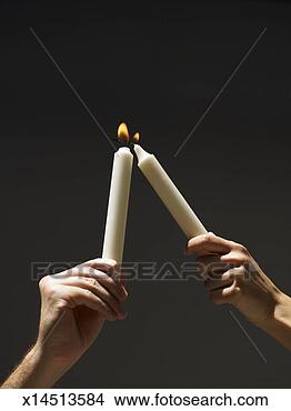 Stock Photo - person holding 
aloft burning 
candle,  other 
person trying 
to light. fotosearch 
- search stock 
photos, pictures, 
images, and photo 
clipart