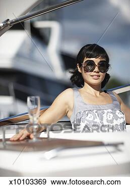 Stock Photograph - portrait of mid 
adult woman on 
yacht, smiling. 
fotosearch - search 
stock photos, 
pictures, images, 
and photo clipart