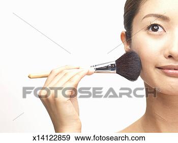 Stock Photograph - woman using powder 
brush, close up 
(cropped). fotosearch 
- search stock 
photos, pictures, 
images, and photo 
clipart