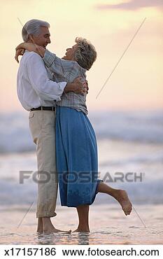 Stock Photo - elderly man and 
woman in embrace 
on beach. fotosearch 
- search stock 
photos, pictures, 
images, and photo 
clipart