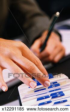 Stock Image - hand sorting through 
index file,  second 
hand writing with 
pen in. fotosearch 
- search stock 
photos, pictures, 
images, and photo 
clipart