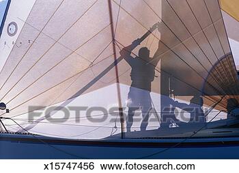 Stock Photo - silhouette of 
two men preparing 
sail on sailboat. 
fotosearch - search 
stock photos, 
pictures, images, 
and photo clipart