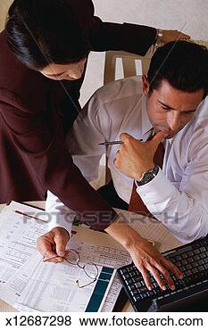Stock Photo - woman leaning 
over man's desk, 
 pressing keys 
on laptop computer; 
man. fotosearch 
- search stock 
photos, pictures, 
images, and photo 
clipart