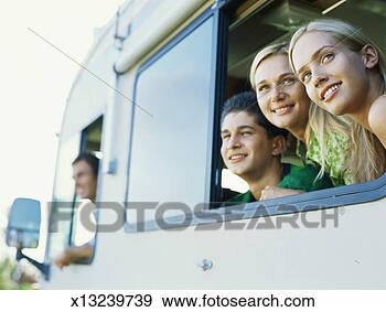 Stock Photograph - mid adult woman 
and a young couple 
looking out of 
a caravan window. 
fotosearch - search 
stock photos, 
pictures, images, 
and photo clipart