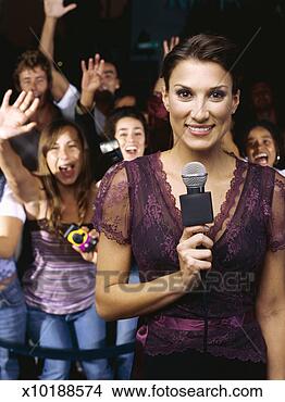 Stock Photo - close-up of a 
tv presenter near 
enthusiastic fans 
at ceremony award. 
fotosearch - search 
stock photos, 
pictures, images, 
and photo clipart