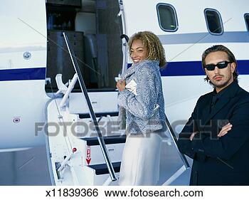 Stock Photo - close-up of two 
people entering 
a private jet. 
fotosearch - search 
stock photos, 
pictures, images, 
and photo clipart