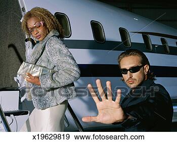 Stock Photograph - close-up of two 
people entering 
a private jet. 
fotosearch - search 
stock photos, 
pictures, images, 
and photo clipart