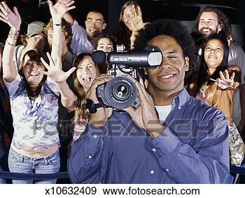 Stock Photograph - front view of 
a cameraman shooting 
at ceremony award. 
fotosearch - search 
stock photos, 
pictures, images, 
and photo clipart