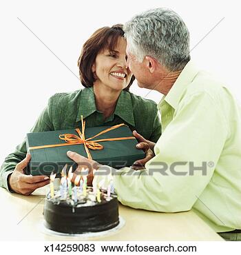 Stock Photo - elderly woman 
giving an elderly 
man a present. 
fotosearch - search 
stock photos, 
pictures, images, 
and photo clipart
