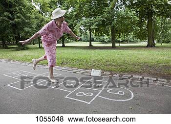 Stock Photo - senior woman plays 
hopscotch trying 
to keep her balance. 
fotosearch - search 
stock photos, 
pictures, wall 
murals, images, 
and photo clipart