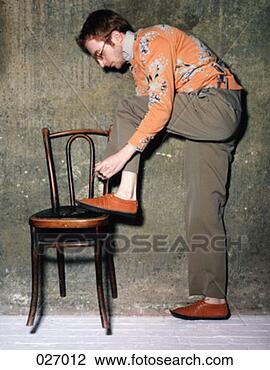 Stock Photo - a man tying his 
shoe. fotosearch 
- search stock 
photos, pictures, 
images, and photo 
clipart